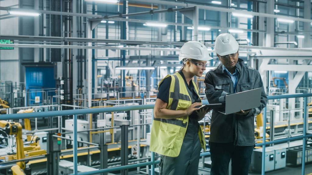 Two Industrial Engineers Use Tablet Computer